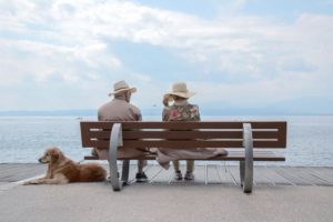 two older individuals sitting on a bench